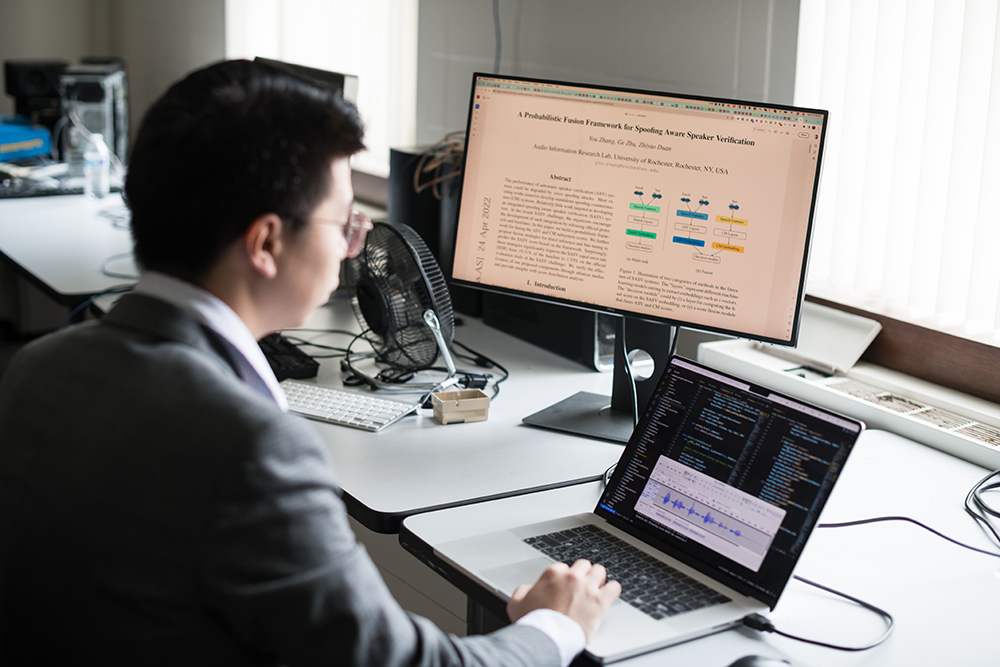 A graduate student working on research at a computer.