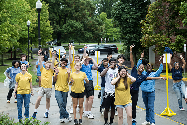 A group of students wearing yellow t-shirts walking down a path.